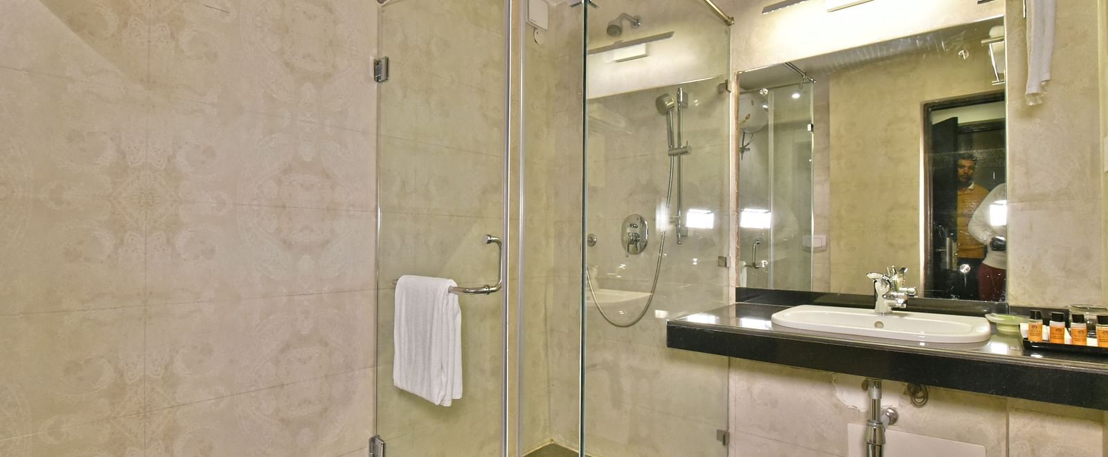 Modern glass-enclosed shower cubicle at DLS Hillcrest Resort, Shimla.